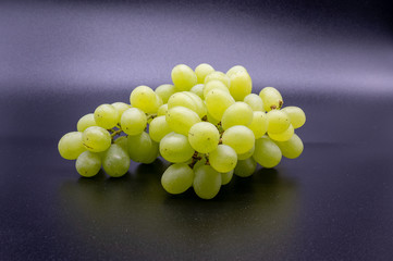 bunch of white grapes on black background
