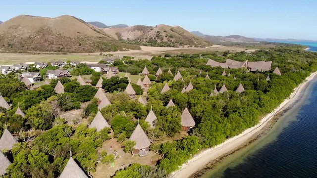 Aerial drone footage of the western part of New Caledonia. The bay of Po&eacute;, The great blue lagoon. Typical houses for tourists in a luxury resort.