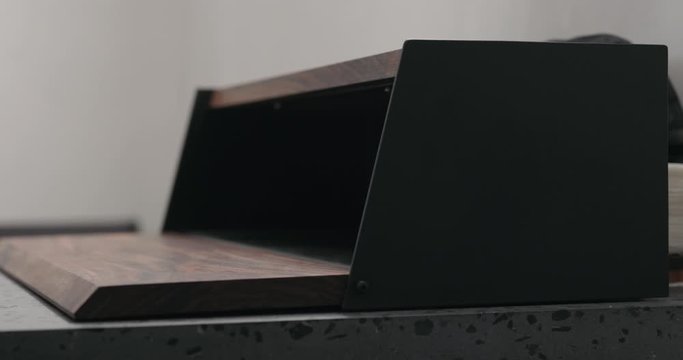 Slow motion man hand check walnut wood breadbox
