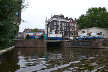 Fototapeta na wymiar River in Amsterdam, city on the river, houses