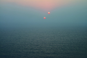 Two Suns Behinde the Blue  Sea