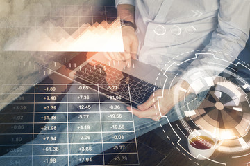 Forex graph with businessman working on computer in office on background. Concept of analysis....