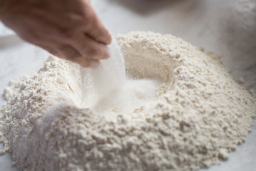 Preparation of Easter cake, also called Pastiera Napoli, typical homemade dessert, with eggs, flour, sugar and vanilla, wheat and colored sugared almonds