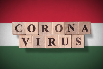 Flag of Hungary with wooden cubes spelling coronavirus on it. 2019 - 2020 Novel Coronavirus (2019-nCoV) concept, for an outbreak occurs in Hungary.