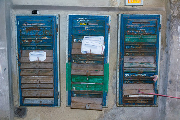 Group of mailboxes with bundles of receipts in an abandoned municipal house