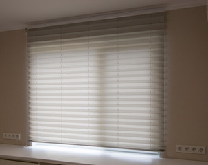 Pleated blinds XL, white color, with 50mm fold close up in the window opening in the interior....