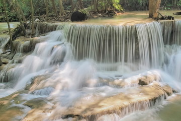 Beautiful soft silky white water flowing on arch rock with nature background, Huay Mae Khamin Waterfall floor 6th (Dong Pee Sua) Kanchanaburi, west of Thailand.
