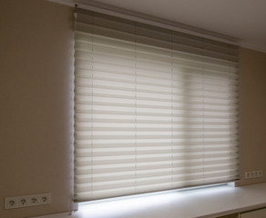 Pleated blinds XL, white color, with 50mm fold close up in the window opening in the interior....