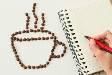 coffee bean concept with notebook on the white background.
