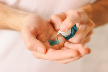 Closeup of man hands using antibacterial gel as preventive measure against contagious disease. Doctor applying sanitizer on palm for protection against coronavirus COVID-19, nCov-19. Safety hygiene