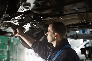 Obraz na płótnie Canvas Auto mechanic working on car engine in mechanics garage. Repair service. authentic. Wrench, Spanner. Close-up shot
