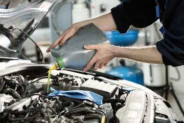 Hand mechanic in repairing car,Change the Oil.Car maintenance, concept. Middle shoot