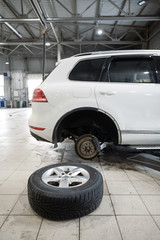 Selective focus disc brake on car, in process of new tire replacement,Car brake repairing in garage