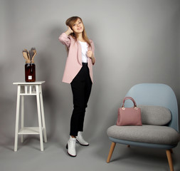 european girl at pink coat posing on camera