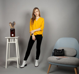european girl at yellow blouse posing on camera