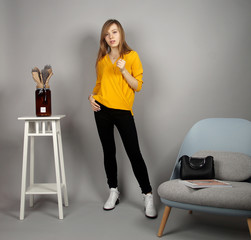 european girl at yellow blouse posing on camera