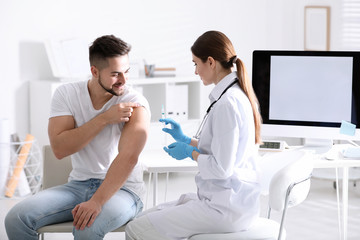 Doctor giving injection to patient in hospital. Vaccination concept