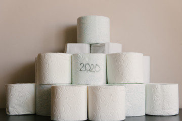 Toilet paper roll background with text toilet paper to 1 package per household. Concept of lack of toilet paper in stores due to coronavirus, Covid-19, hygiene, panic.