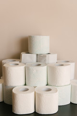 Toilet paper roll background with text toilet paper to 1 package per household. Concept of lack of toilet paper in stores due to coronavirus, Covid-19, hygiene, panic.