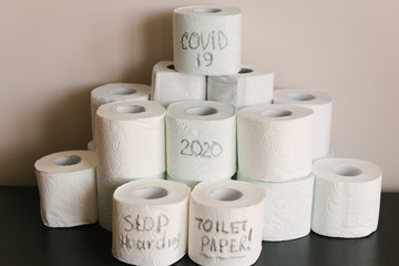 Toilet paper roll background with text toilet paper to 1 package per household. Concept of lack of toilet paper in stores due to coronavirus, Covid-19, hygiene, panic.