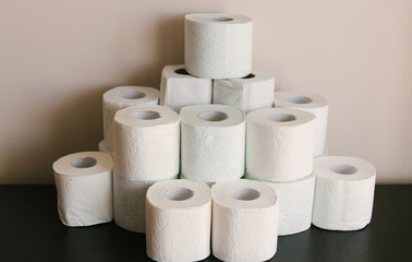 Toilet paper roll background with text toilet paper to 1 package per household. Concept of lack of toilet paper in stores due to coronavirus, Covid-19, hygiene, panic.