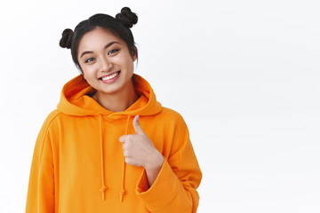 Sounds good. Supportive cute asian girl, team member smiling joyfully, show thumb up and nod agreement, accept interesting idea, like plan or choice, rate excellent project, white background