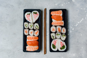 food delivery. set of sushi and rolls with salmon and shrimp. service food order online and home delivery during the COVID-19 coronavirus quarantine . concept layout 2 for the price of 1.