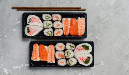 food delivery. set of sushi and rolls with salmon and shrimp. service food order online and home delivery during the COVID-19 coronavirus quarantine . concept layout 2 for the price of 1.