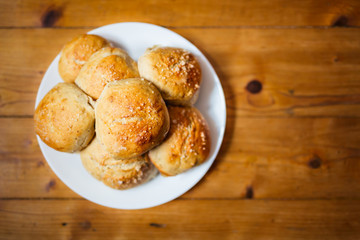 Fresh salty bread buns pastry topped with salt