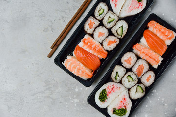 food delivery. set of sushi and rolls with salmon and shrimp. service food order online and home delivery during the COVID-19 coronavirus quarantine . concept layout 2 for the price of 1.