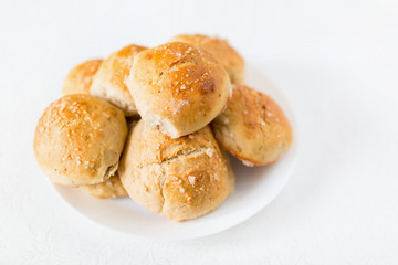 Obraz na płótnie Canvas Fresh salty bread buns pastry topped with salt