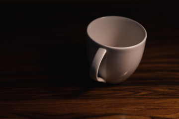 white cup on wooden table