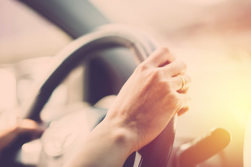 Woman hand driving car close up. vintage filter