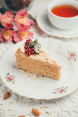  Slice of cake with berries and cream. A piece of Napoleon cake on a white plate.