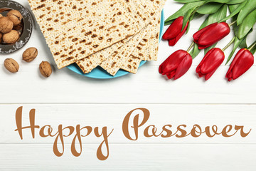 Flat lay composition with matzos on white wooden background. Passover (Pesach) celebration