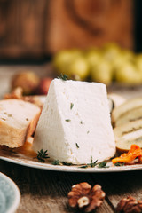 Flatley cheese plate with figs. Snacks for the company. Set of cheeses on a plate with honey and nuts.