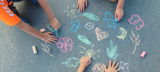 Children's drawings on the asphalt with chalk. Selective focus. © yanadjan