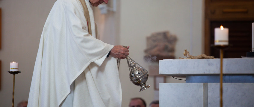 The priest of the Roman Catholic Church censers censer during the Holy Mass in the church. Feast of the Body of the Lord