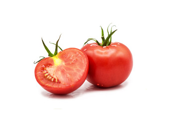 Ripe fresh organic tomato and half a tomato in dew drops isolated on a white background