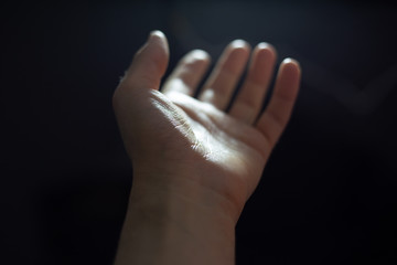 Close-up of male palm on black background.