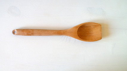 Wooden spoon and kitchen utensils on the table