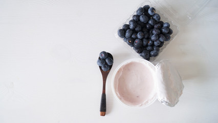 Blueberry yogurt on a white wooden table. Fresh yogurt. Healthy eating concept. High Resolution...
