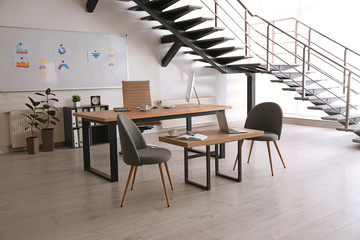 Fototapeta na wymiar Stylish office interior with large wooden table
