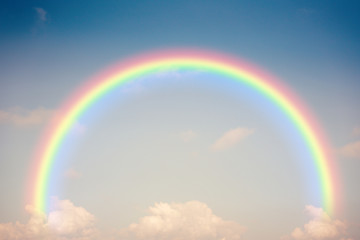Retro blue sky and clouds with rainbow