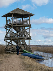 landscape with dirt road and bird watching tower