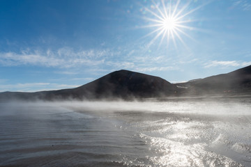 Fototapeta premium Sunrise over a foggy beach at Pendulum Cove, Deception Island, Antarctica