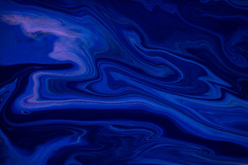 Fluid art texture. Abstract backdrop with mixing paint effect. Liquid acrylic artwork with trendy mixed paints. Classic blue color of the year 2020. Blue, black and white overflowing colors