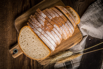 Sliced loaf of bread on a chopping board.