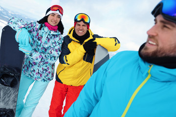 Group of friends with equipment in snowy mountains. Winter vacation