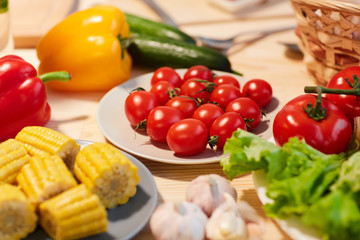Close-up of fresh tomatoes corns and other vegetables on the table